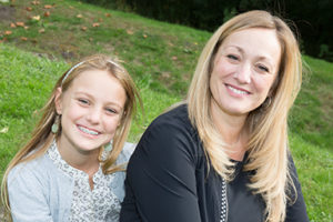 Mother and daughter smiling at the camera