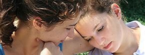 Mother and daughter close hug