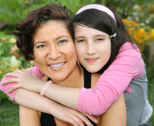 Daughter huging her mother in a park