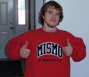 Young man in Mismo Gymnastics sweatshirt with two thumbs up