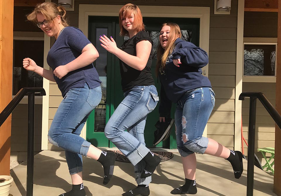 Three friends on one foot on the front porch Youth Homes