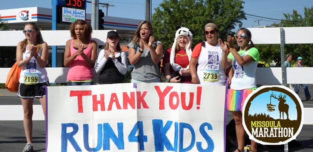 People holding up a sign Thank You! Run 4 Kids