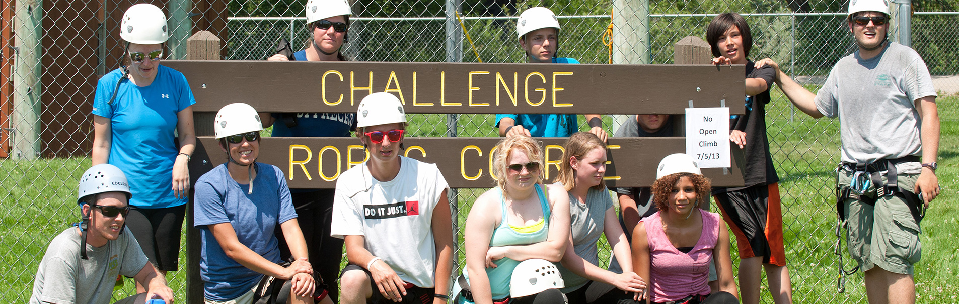 Ropes course group shot in front of sign