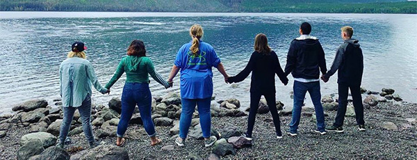 Hand in hand by a river or lake